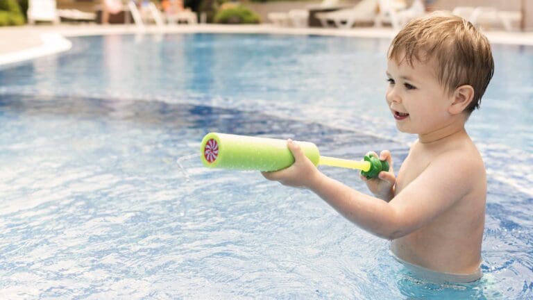 Children exploring water play with cups, buckets, and toys at Starfish Early Learning Centre