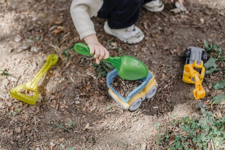 Children exploring outdoor play spaces with natural elements at Starfish Early Learning Centre