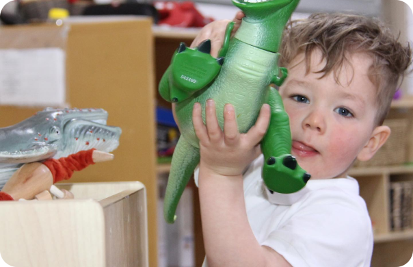 Child joyfully playing in a nurturing educational environment, reflecting the values of creativity and exploration at Starfish Early Learning Centre.