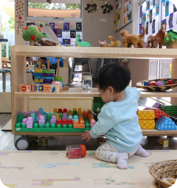 Toddler playing with colourful educational toys in a nursery classroom at Starfish Early Learning Centre