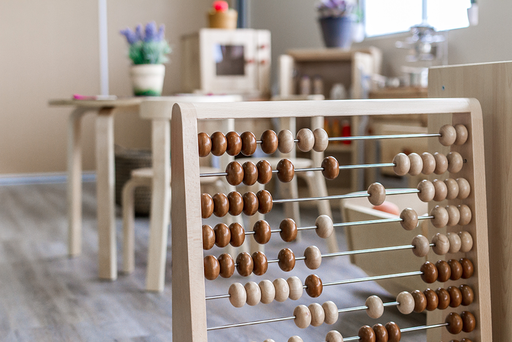 Wooden abacus learning toy in a childcare classroom supporting early maths and hands-on early learning.