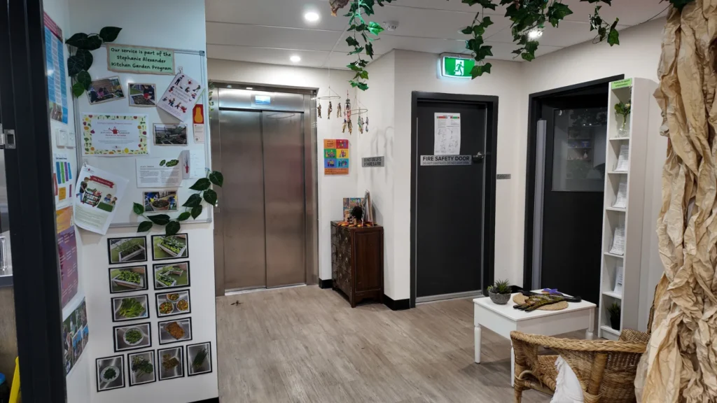 Family information displays and natural décor create a welcoming, community-focused environment at Starfish ELC Essendon.