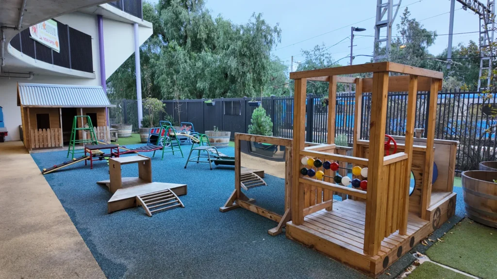 Outdoor play area with wooden climbing equipment at Starfish Early Learning Centre Essendon