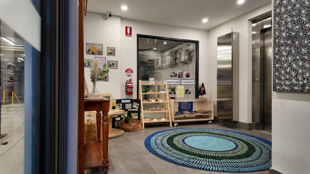 Starfish Early Learning Centre Essendon childcare interior with learning displays, wooden shelves and a circular play rug
