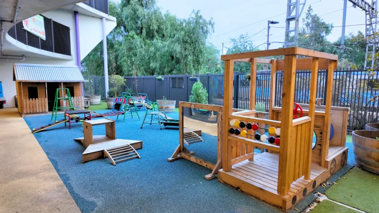 Outdoor play space with wooden play structure and activity areas at Starfish ELC Essendon