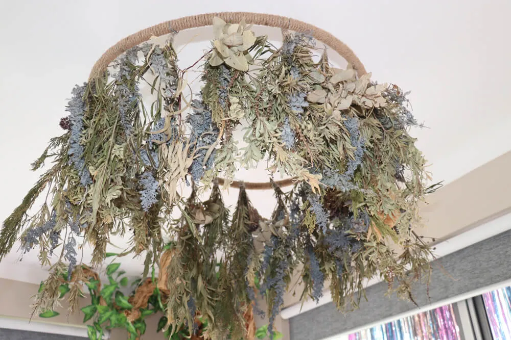 Natural dried foliage mobile hanging in an early learning classroom inspired by Reggio Emilia environments.