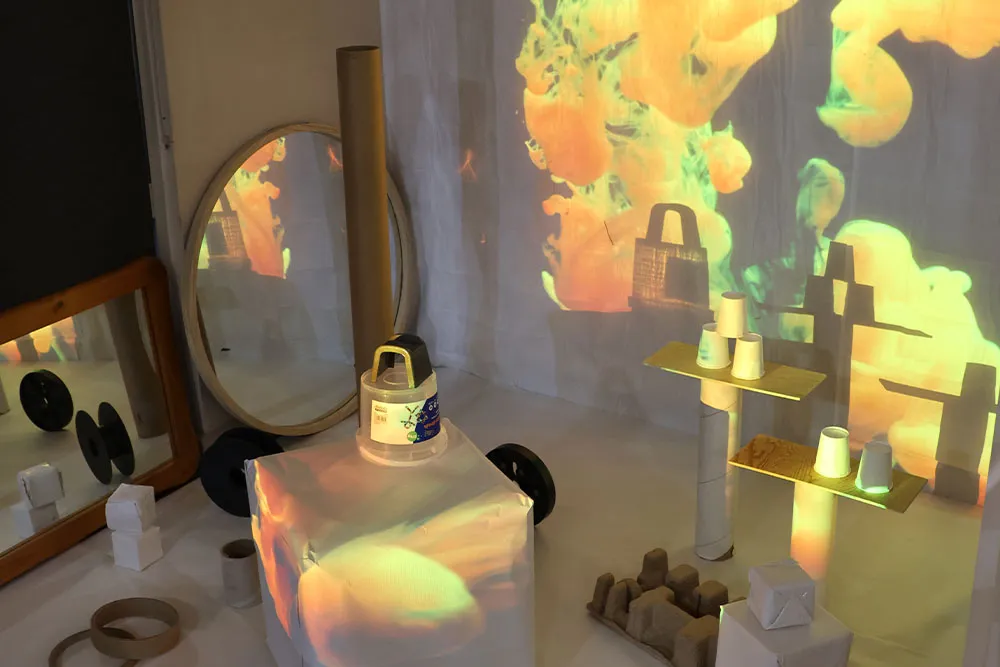 Childcare sensory exploration area with light projections, mirrors and learning materials supporting early learning.
