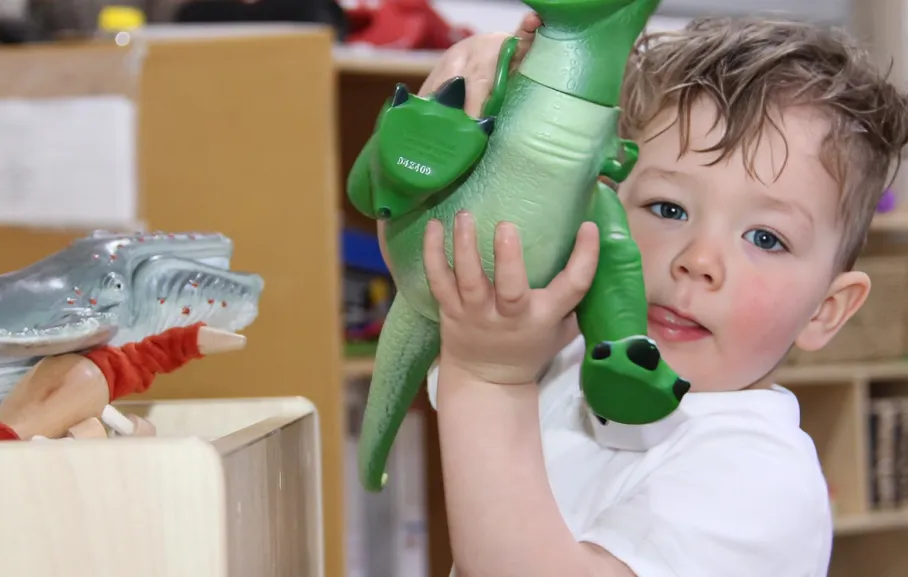 Child joyfully playing in a nurturing educational environment, reflecting the values of creativity and exploration at Starfish Early Learning Centre.