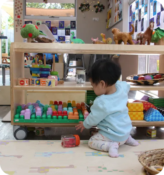 Toddler playing with colourful educational toys in a nursery classroom at Starfish Early Learning Centre